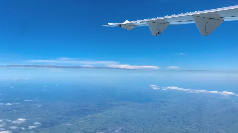 Earth from above with an aeroplane wing in view