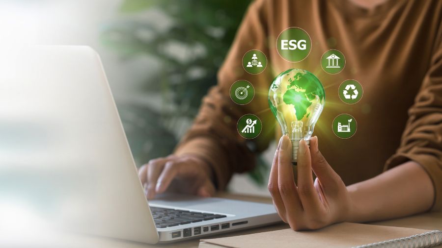 a lady holds a lightbulb with ESG icons floating around