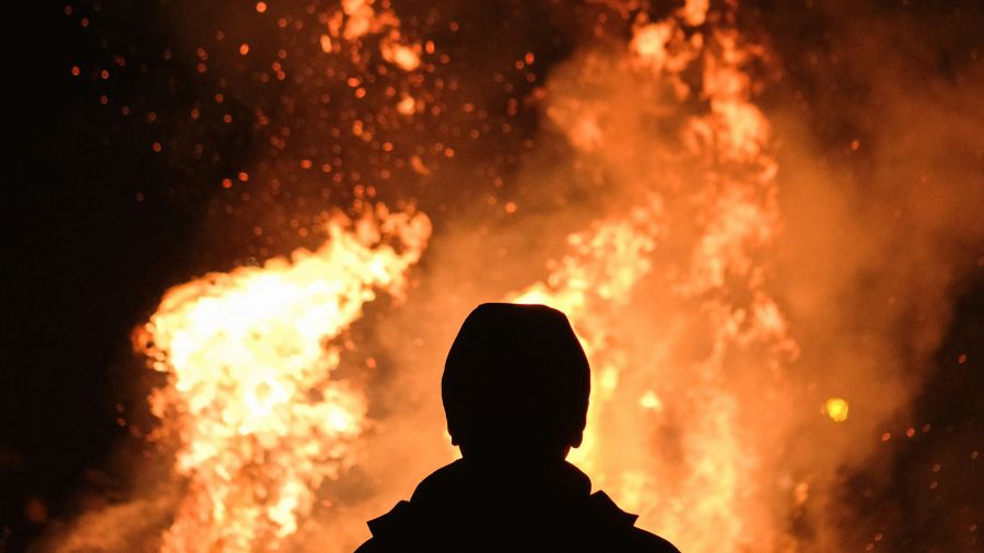 human silhouette against fire