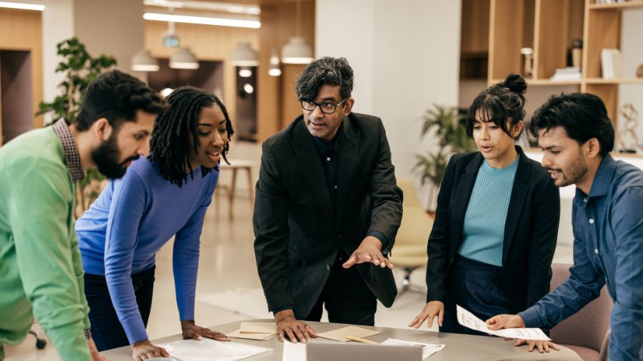man demonstrates next steps in team meeting