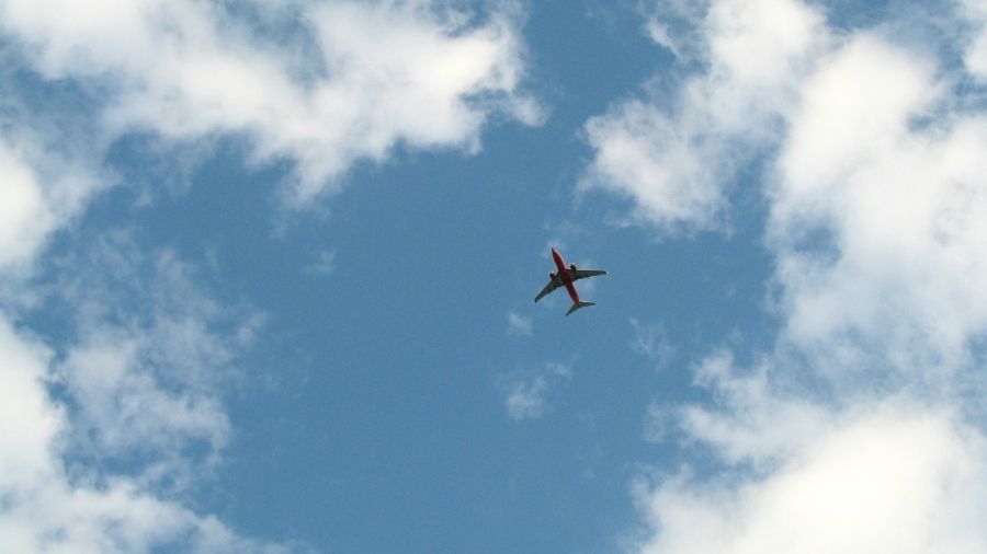 passenger plane from below surrounded by sky
